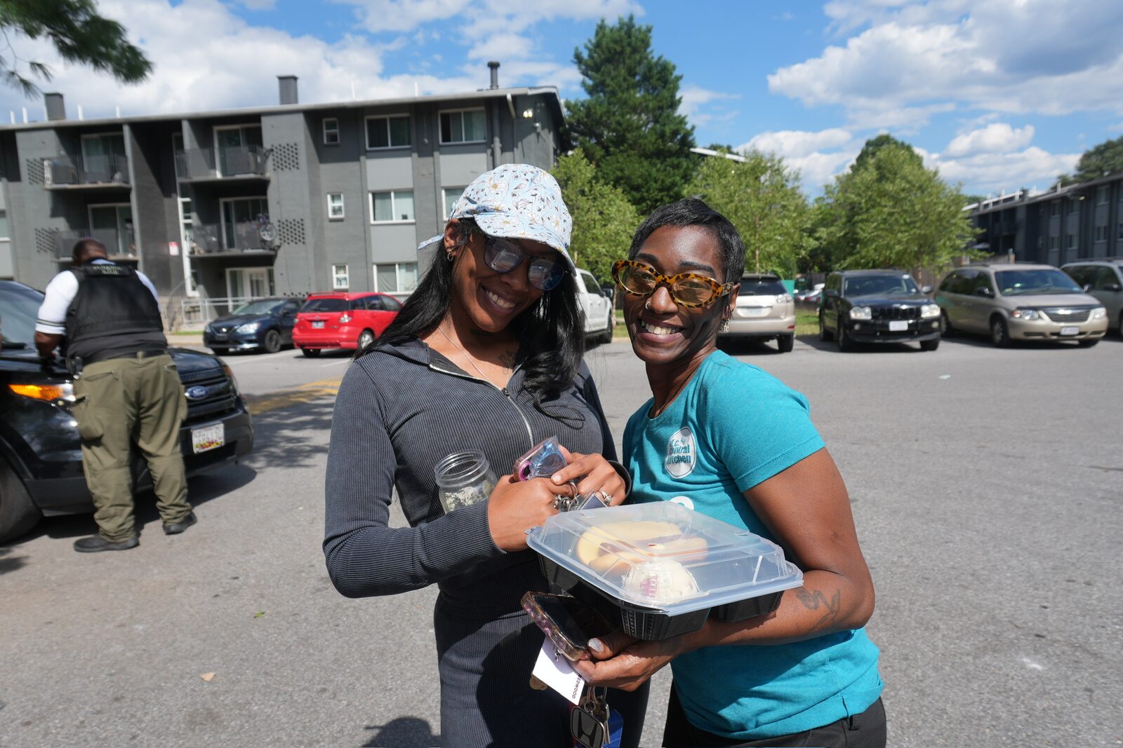 Two women smiling at a community event